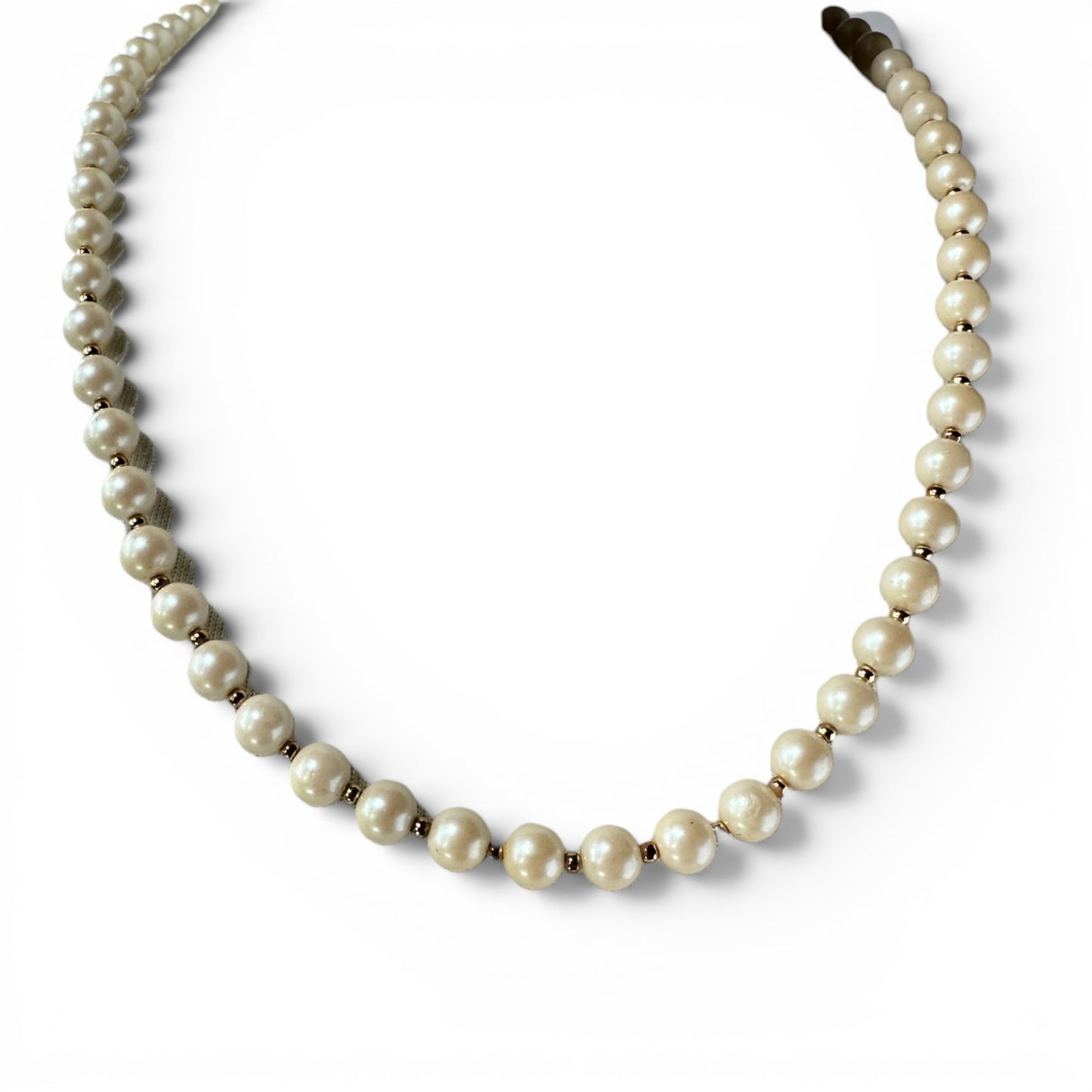 Single-strand faux pearl necklace with gold-tone rondelle spacer beads, shown flat on white surface, approx 24 inches