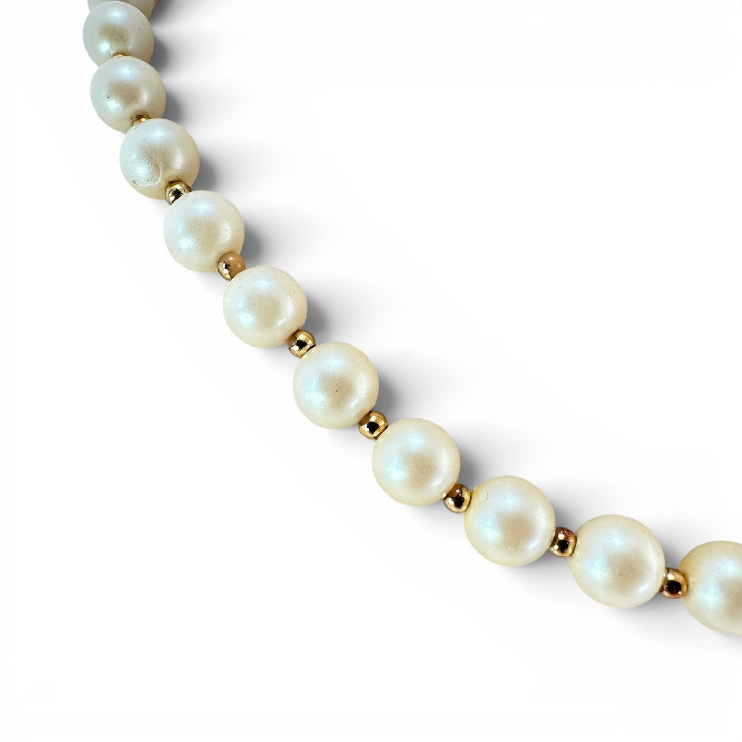 Cream faux pearl necklace displayed on bust form in double-loop configuration showing length and bead scale