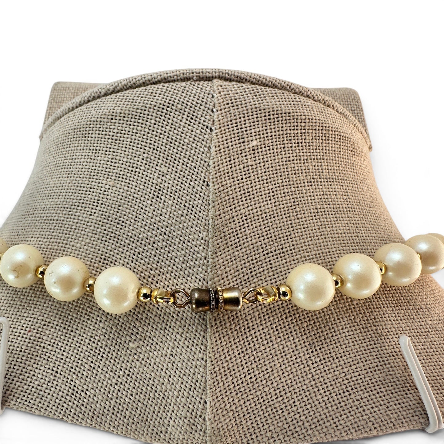 Reverse of pearl necklace showing gold-tone barrel screw clasp and stringing construction