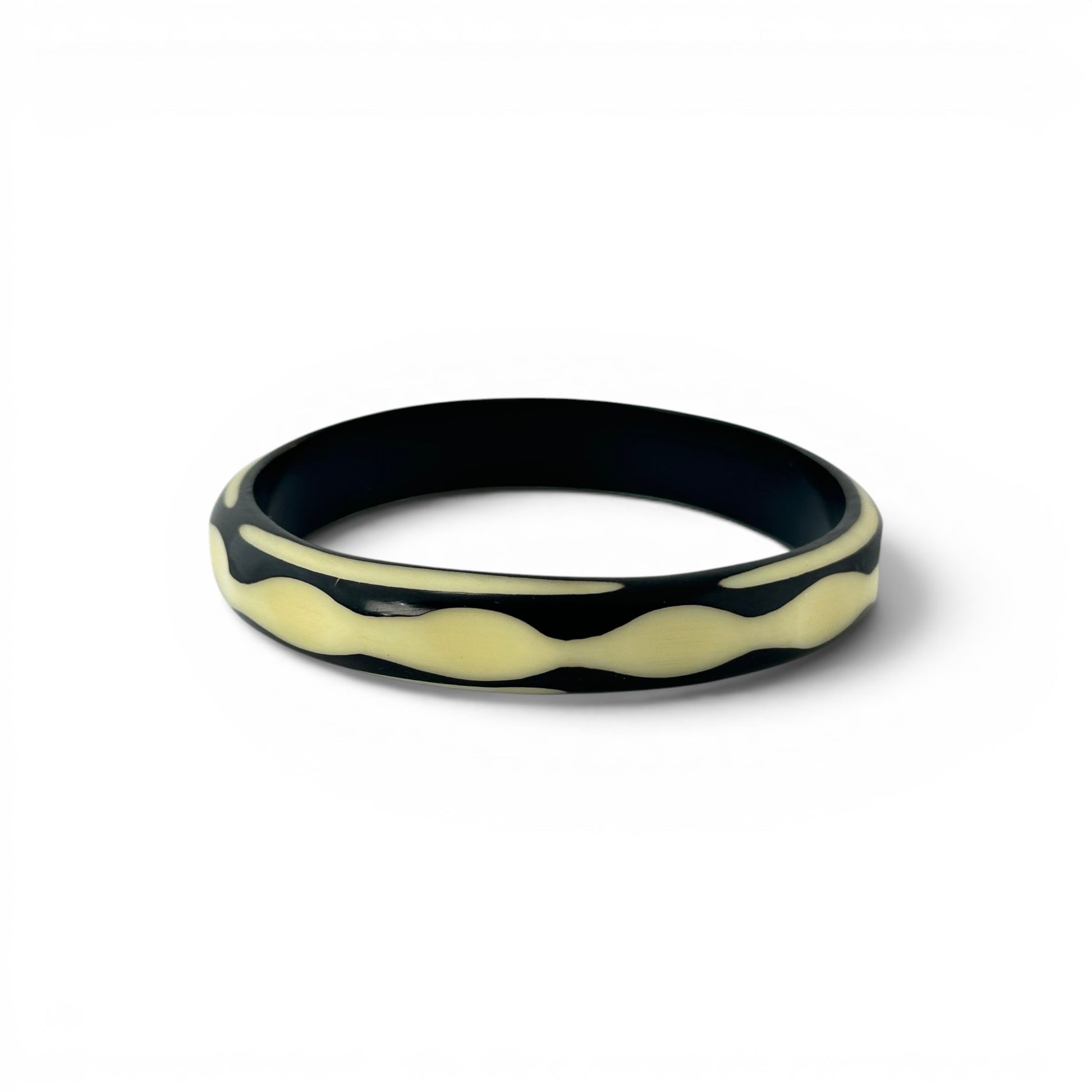 Hand-carved two-tone Bakelite bangle — angled view