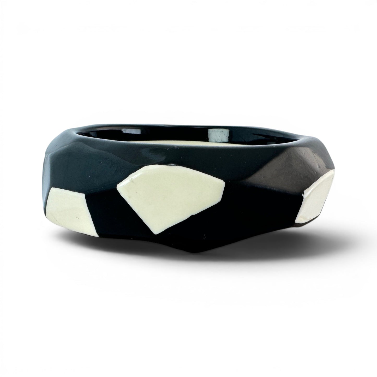 Interior view of slip-on bangle revealing smooth ivory-cream inner surface and two-tone construction