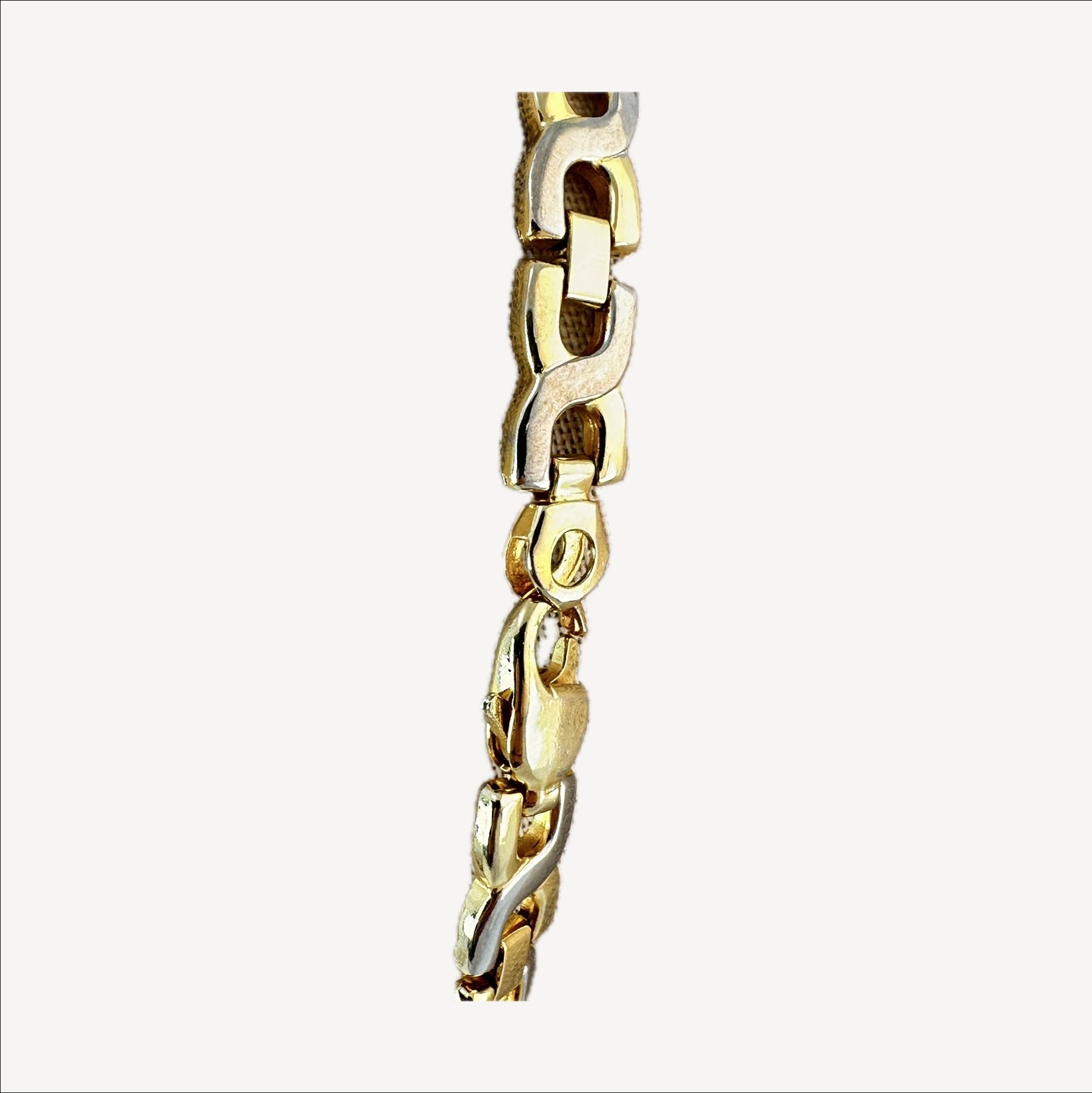 Two-tone link necklace — macro of alternating gold and silver links