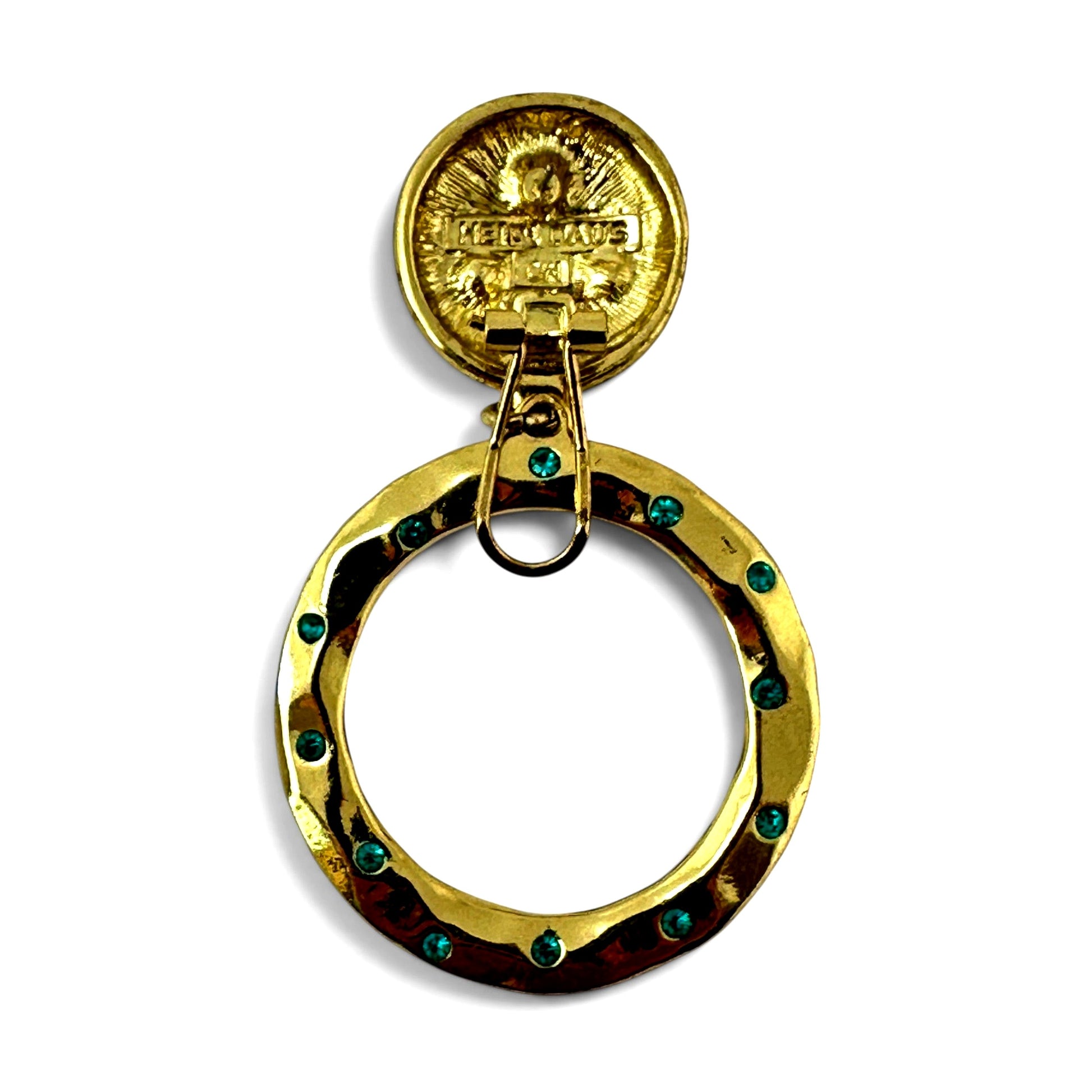 Reverse of disc top showing embossed Heidi Daus signature mark with decorative sun and angel motif