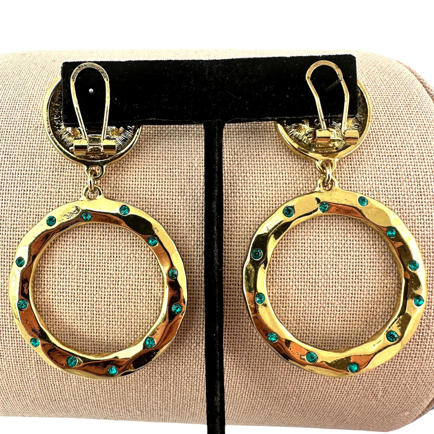 Detail of omega tension clip-back mechanism on reverse of gold-tone disc stud earring top