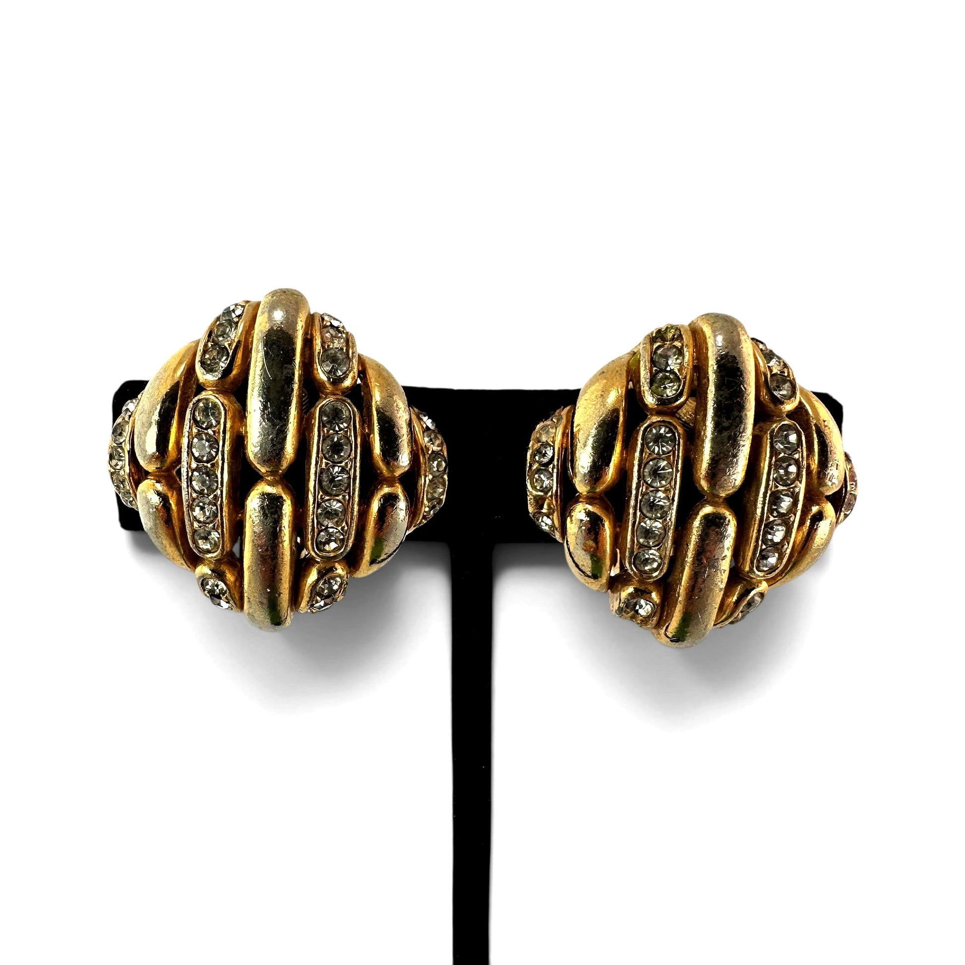 Ciner signed domed clip-on earrings in antiqued gold-tone with pavé clear rhinestones, lozenge silhouette, front view