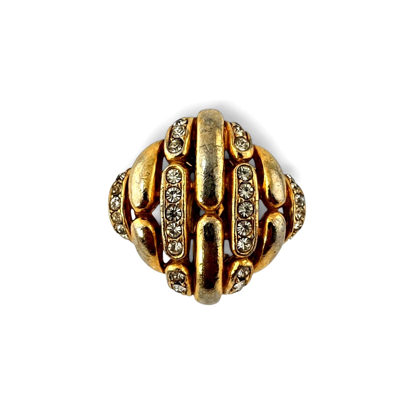 Close-up of curved gold-tone lattice bars and pavé rhinestone channel rows on domed Ciner clip earrings