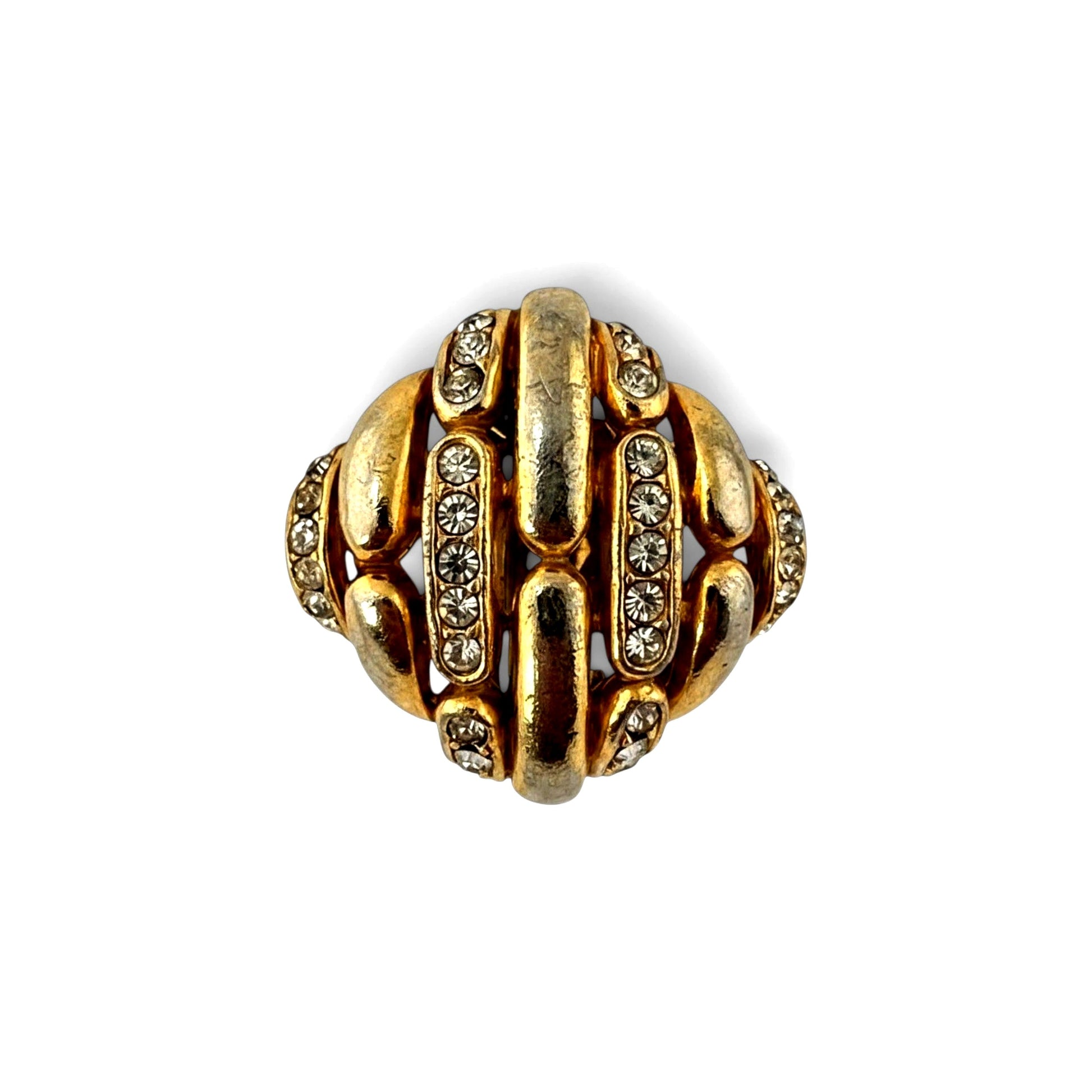 Close-up of curved gold-tone lattice bars and pavé rhinestone channel rows on domed Ciner clip earrings