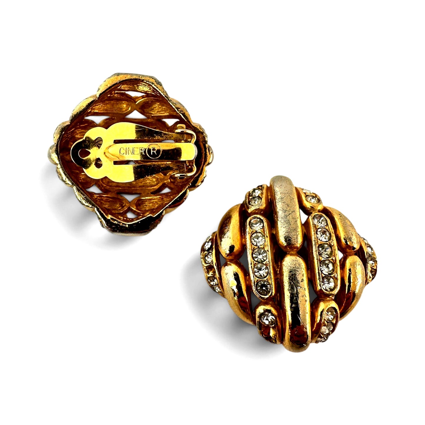 Reverse of Ciner clip-on earrings showing open-work quatrefoil filigree back plate and lever clip stamped CINER