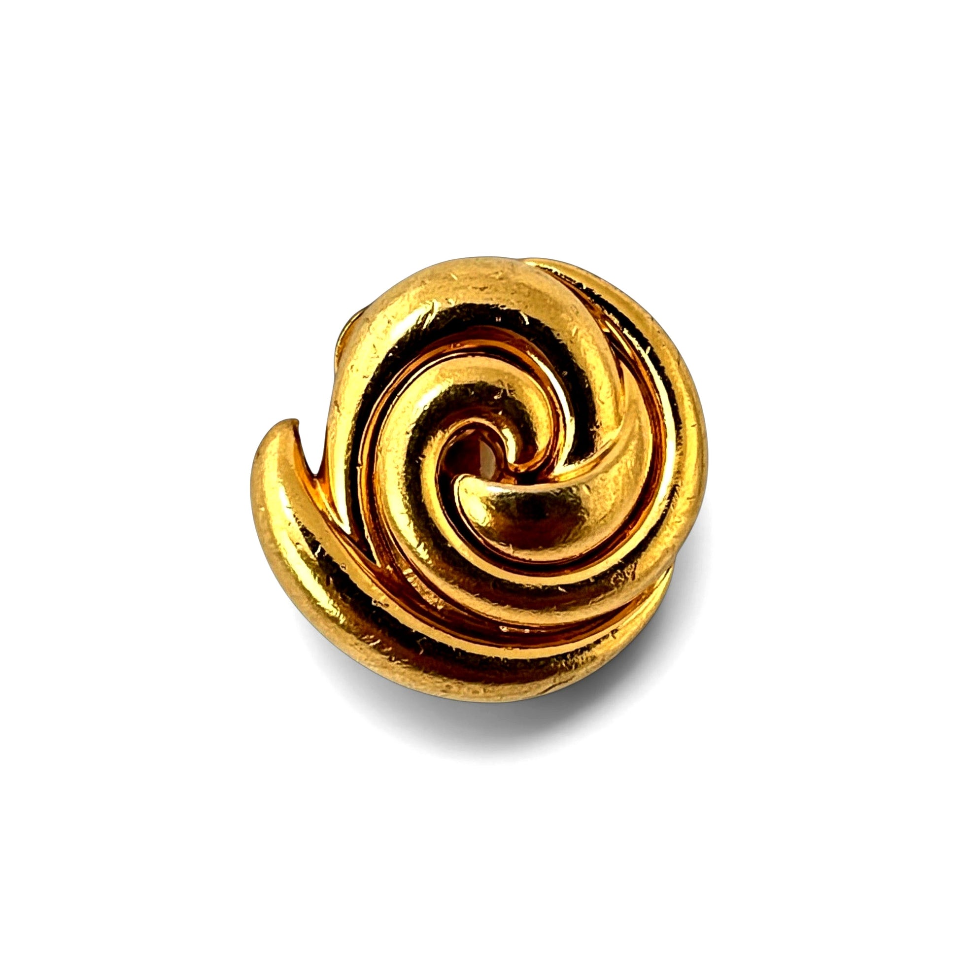 Close-up of gold-tone spiral earring showing smooth flowing ridges and coiled nautilus form with curling tail element at l...
