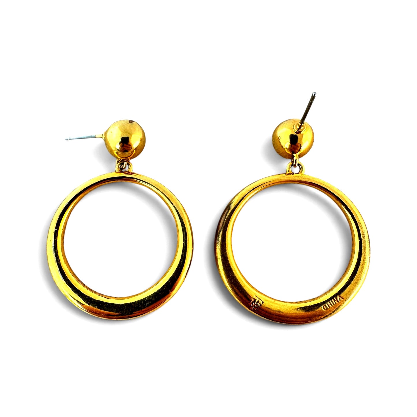 Reverse of gold-tone hoop earring showing stamped mark reading CHINA and partial maker's initial on base metal back