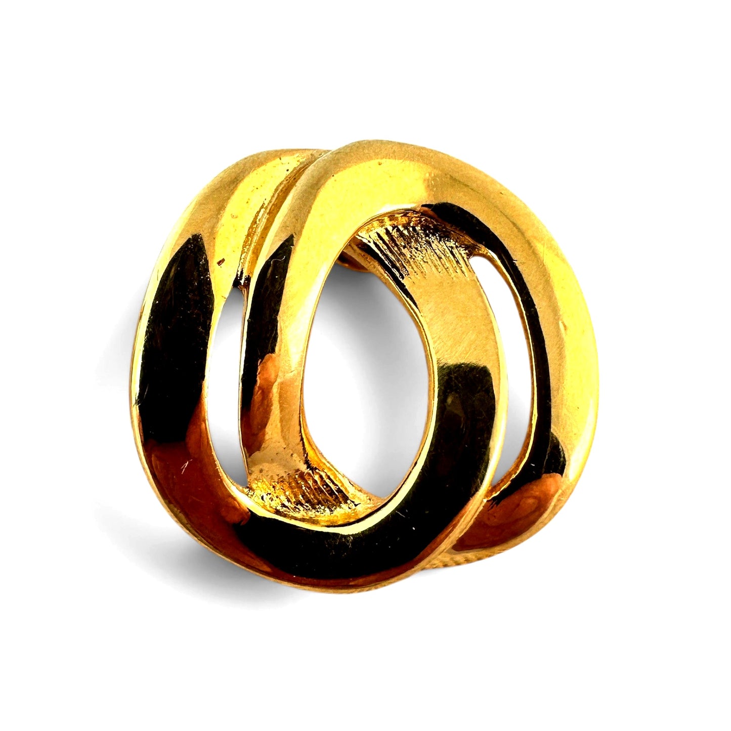 Close-up of gold-tone interlocking oval knot showing smooth polished front surface and sculptural form