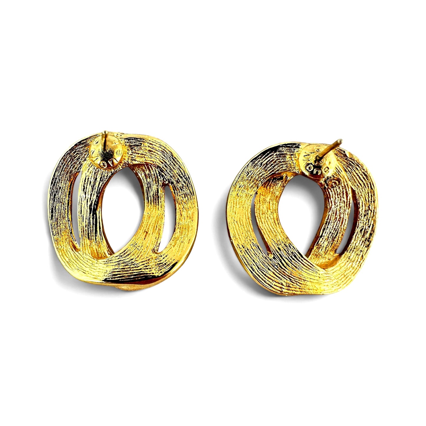 Reverse of gold-tone knot earrings show brushed linear texture, post fitting, and stamped oval cartouche at base