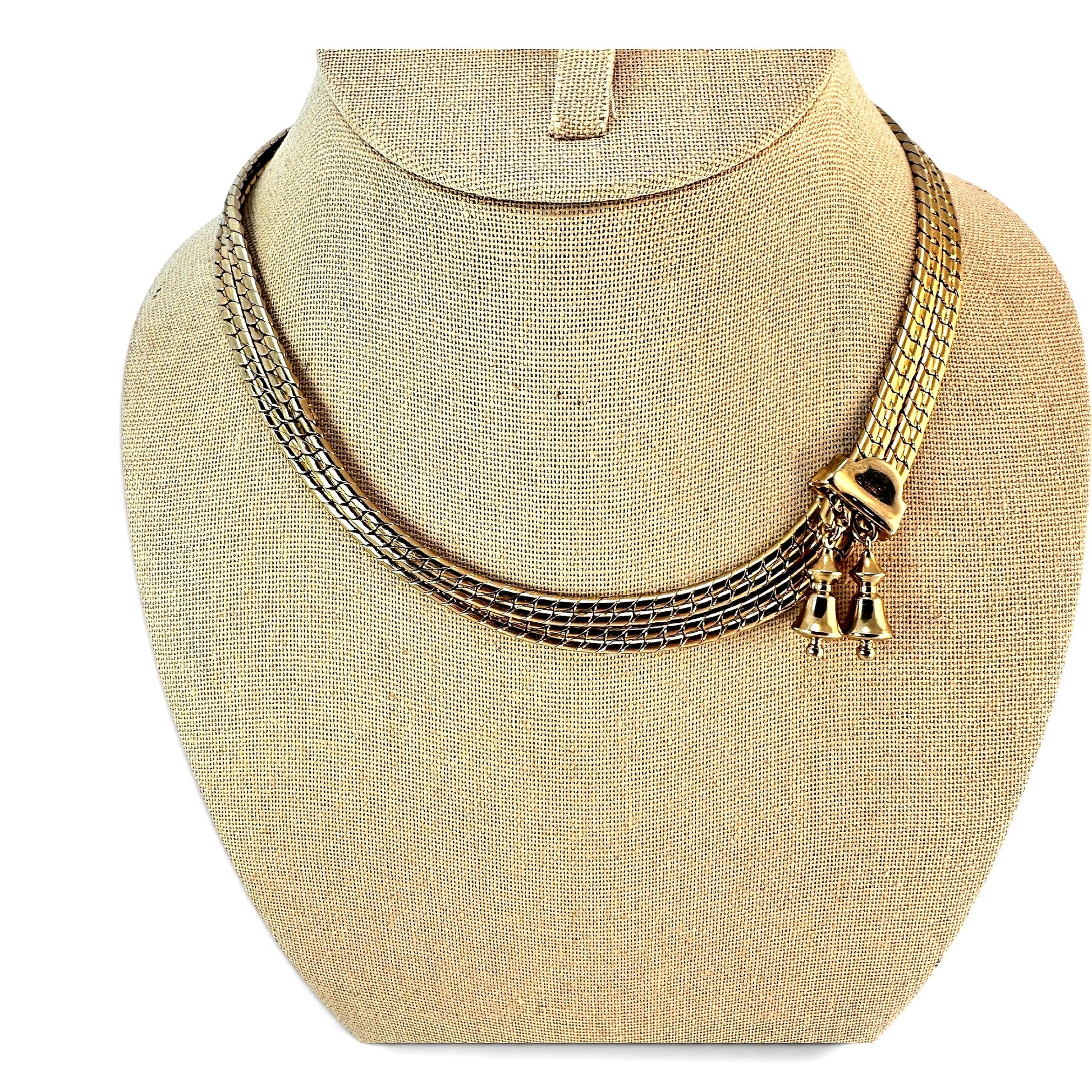 Gold-tone flat snake chain bolo necklace with black enamel rectangular slider and two dangling bell charms, full length view