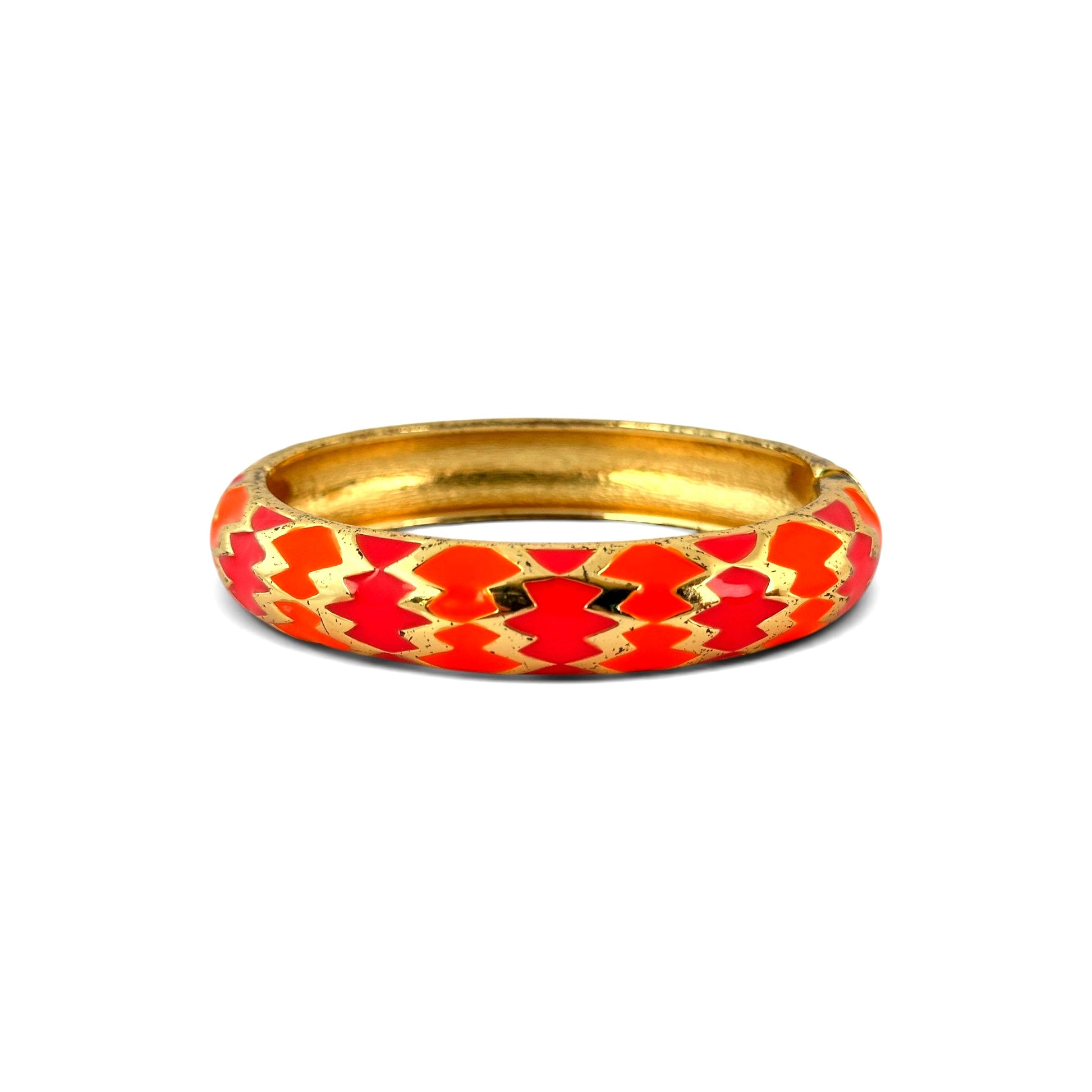 Gold-tone hinged clamper bangle with orange and fuchsia chevron enamel pattern, domed convex profile, closed view