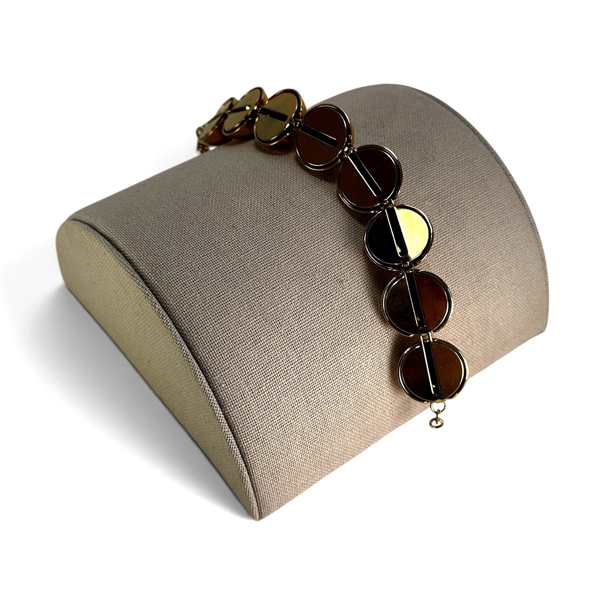 Close-up of mirror-polished hollow gold-tone ball beads on Monet vintage bracelet showing linked metal construction