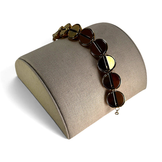 Close-up of mirror-polished hollow gold-tone ball beads on Monet vintage bracelet showing linked metal construction
