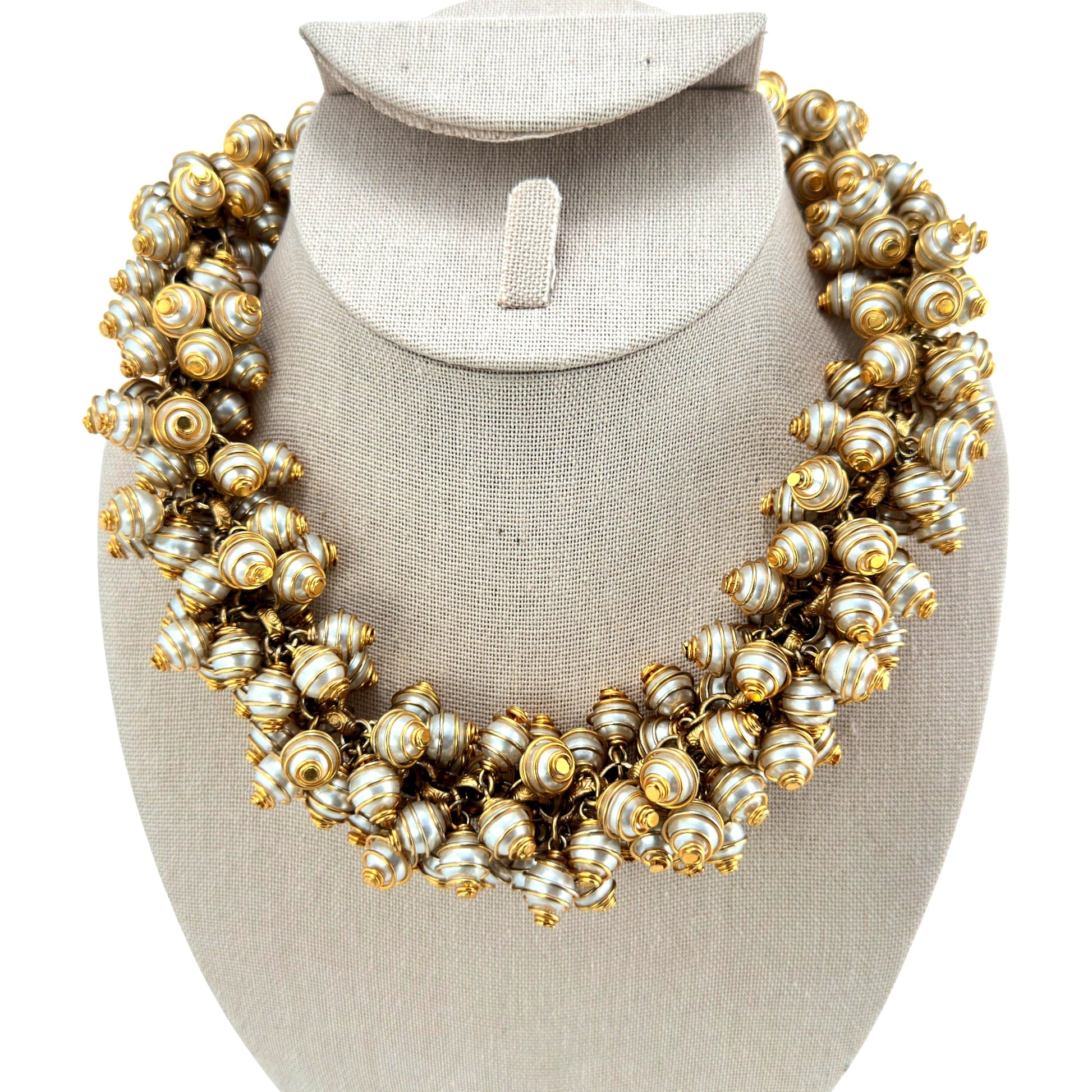 Clustered bib necklace with spiral gold-tone wire-wrapped faux pearl beads linked by jump rings, toggle clasp, front view