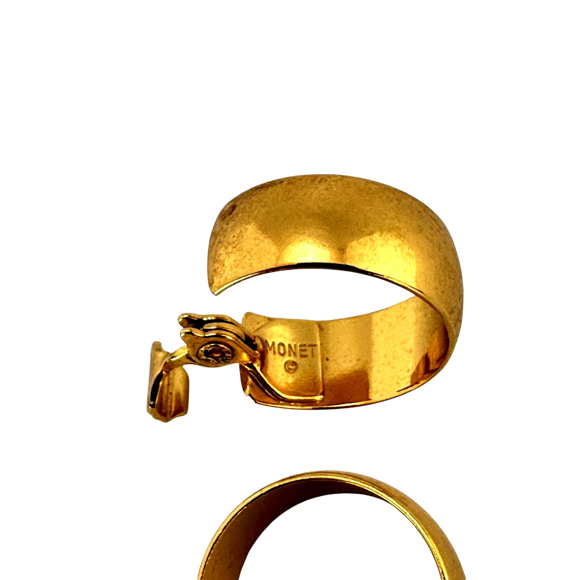 Close-up of Monet hallmark on gold tone hoop earring clasp