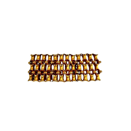 Side view of goldtone ridged sculptural bracelet