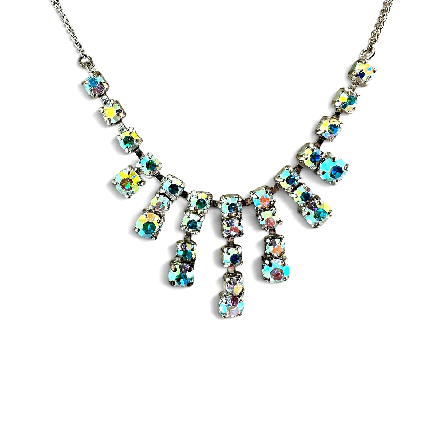 Silver-tone fringe bib necklace with five vertical columns of aurora borealis rhinestones in alternating square and round ...