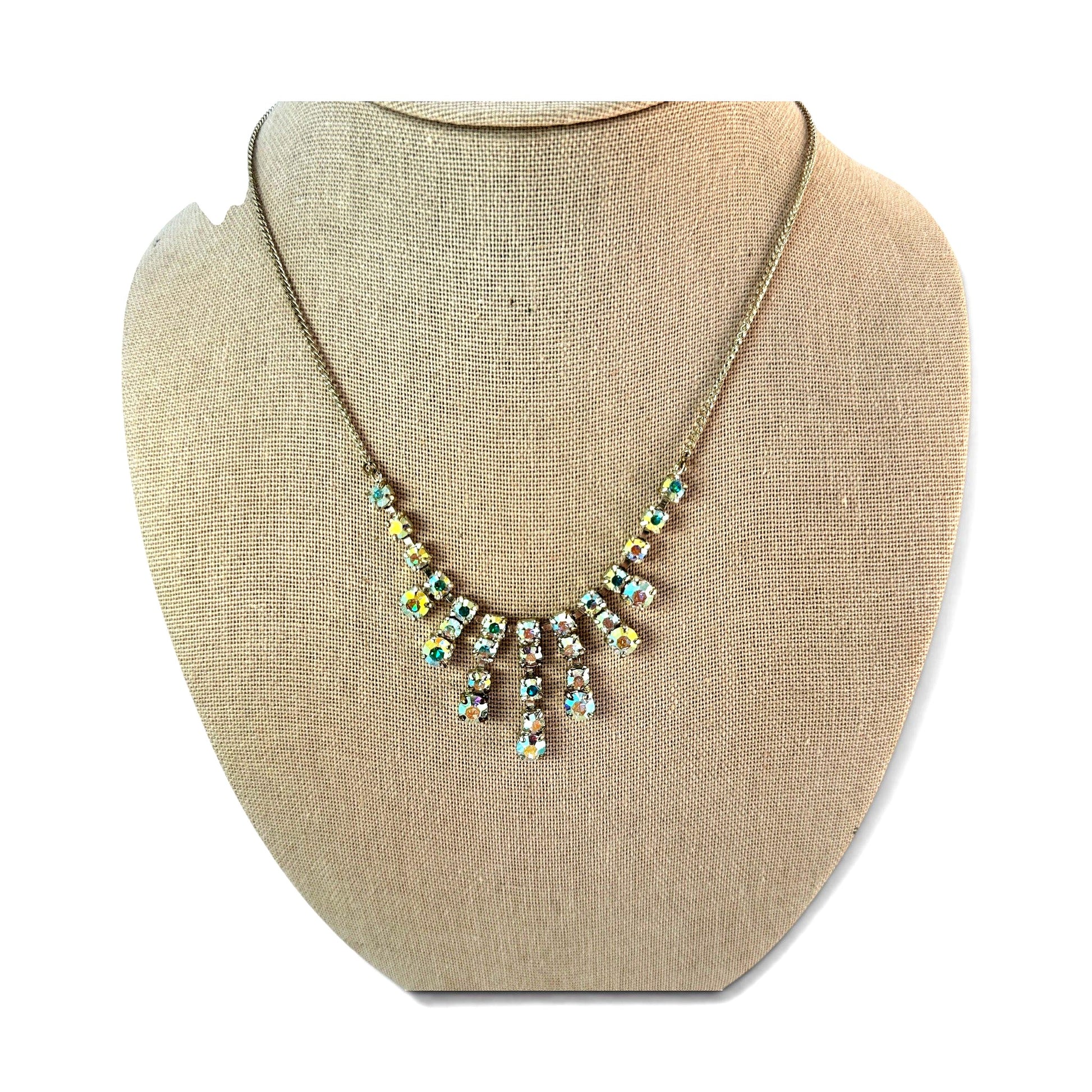 Detail of linking bar construction between rhinestone clusters connecting fringe drops to chain section