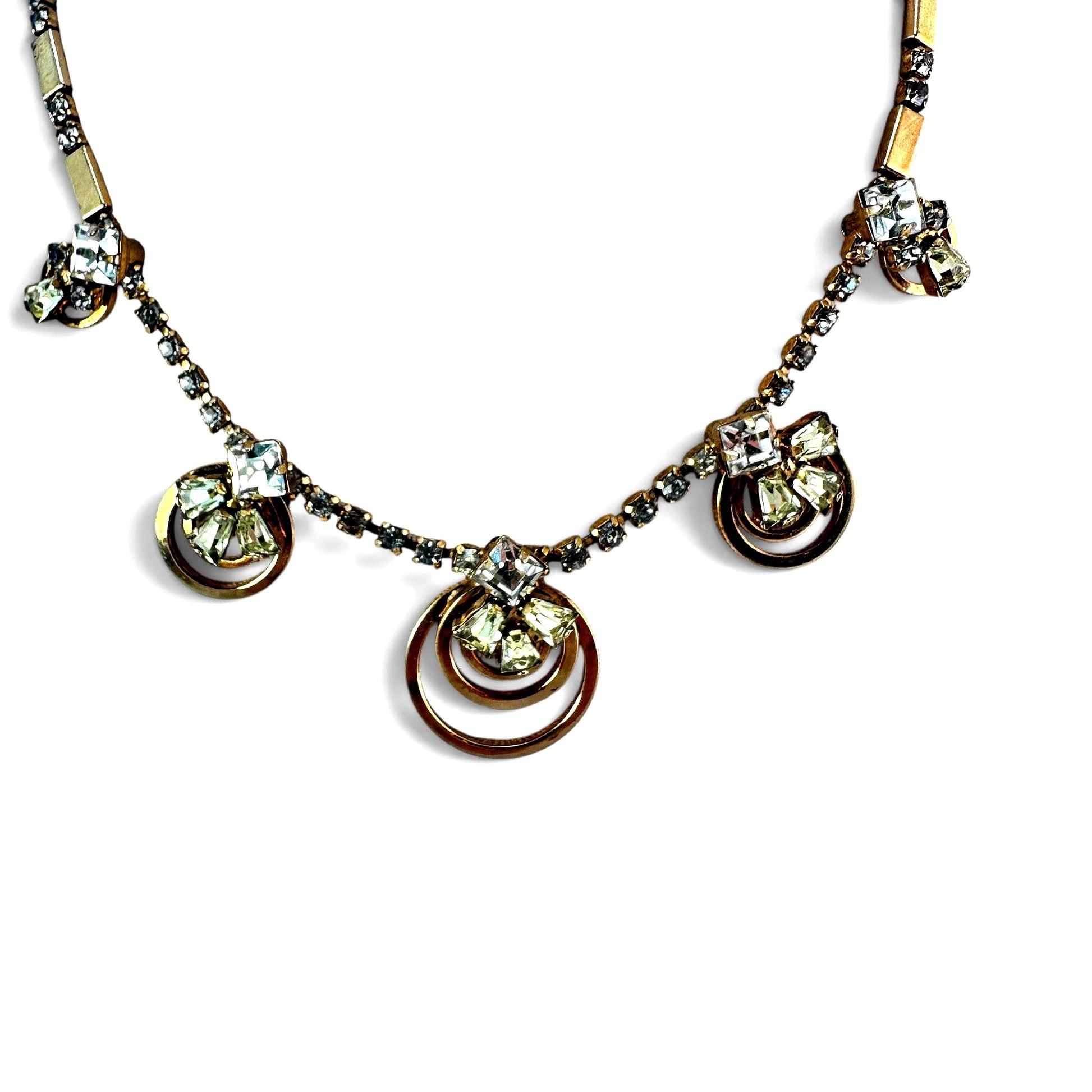 Reverse view of gold-tone rhinestone necklace showing hook clasp and safety chain extender with swivel clip terminal