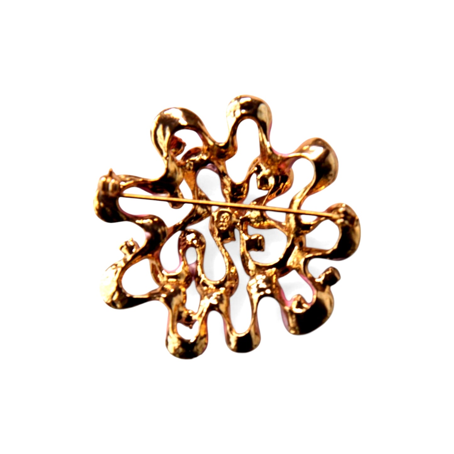 Reverse of circular gold-tone cast brooch showing rollover safety clasp, straight pin stem, and small stamped mark near ce...