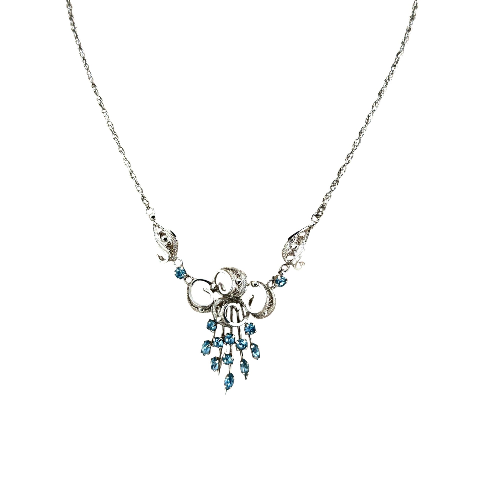 Scrollwork cannetille centerpiece with radiating pin-style aquamarine drops and torpedo spacer links, front view