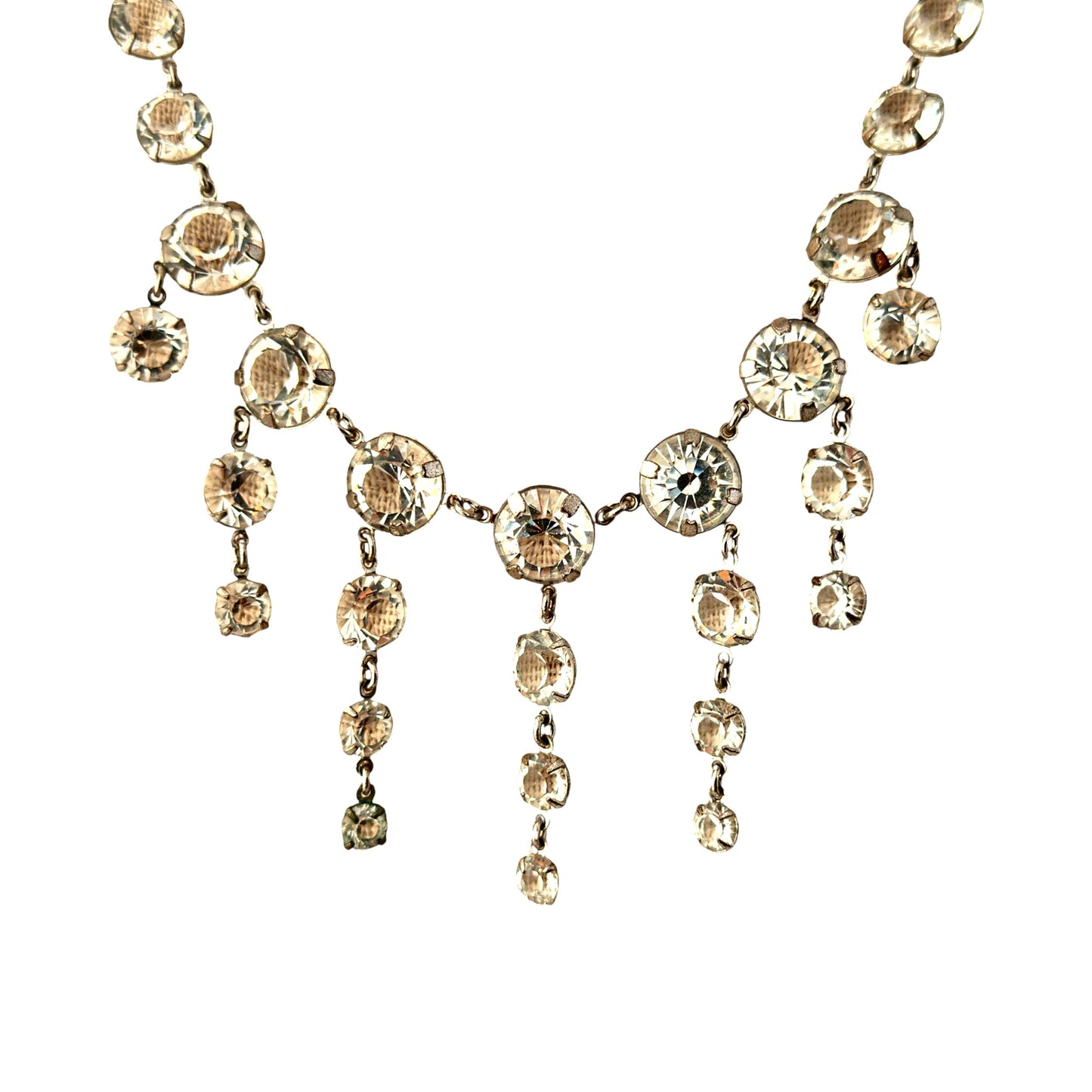 Close-up of open-back collet-set round rhinestones linked in continuous chain forming necklace body