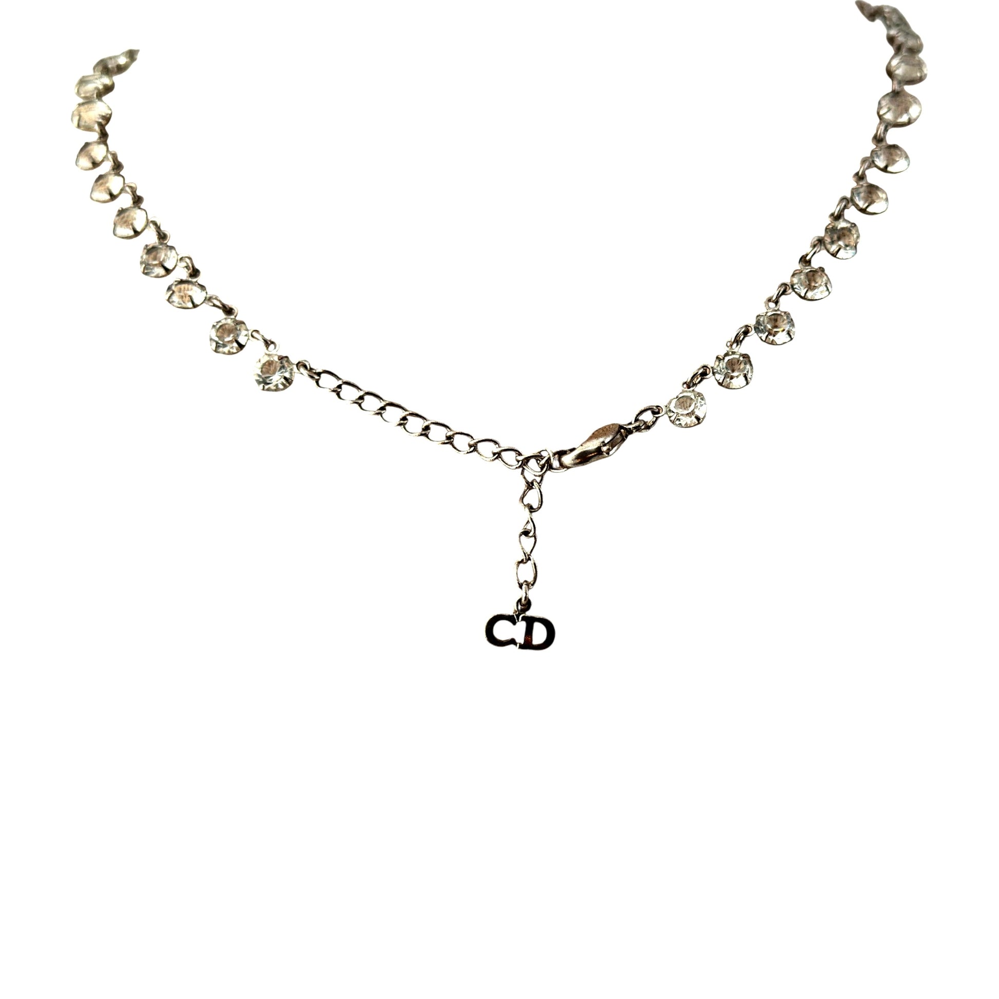 Detail of chandelier bib section showing horizontal bar with five descending rhinestone drop chains of varying lengths