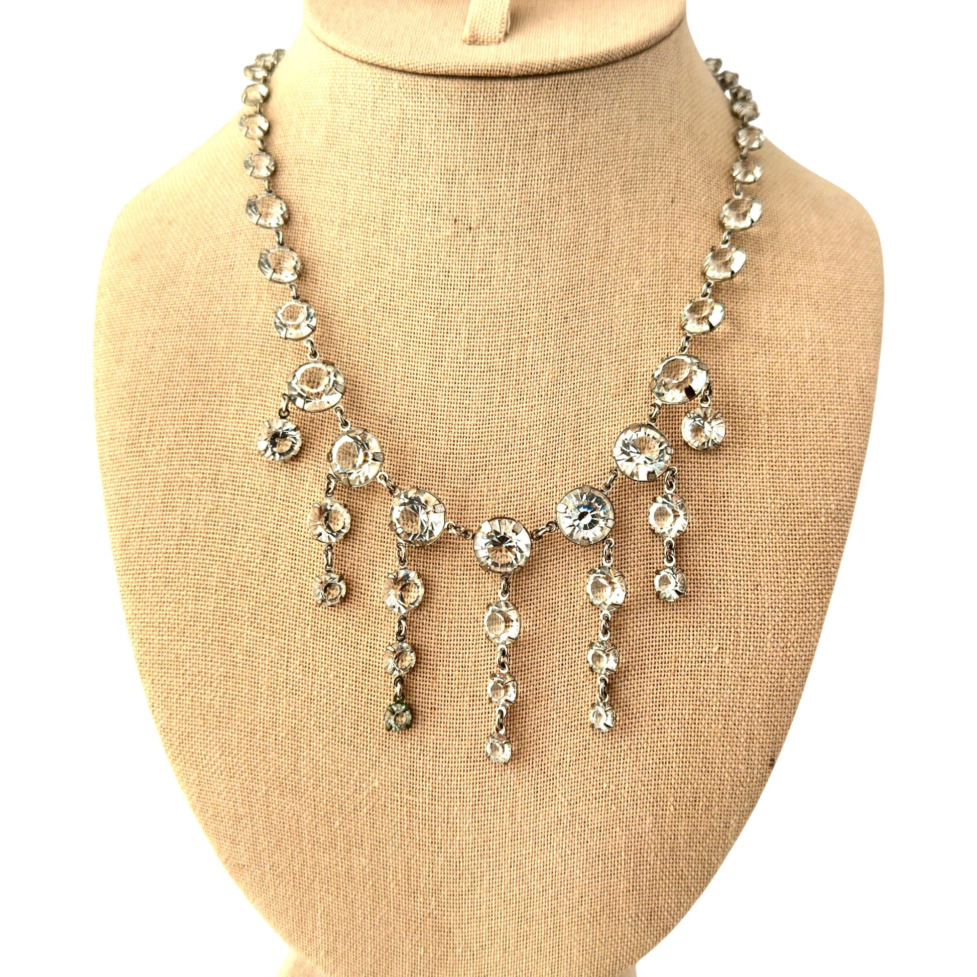 Lobster claw clasp with extender chain and small CD monogram charm tag on silver-tone rhinestone necklace