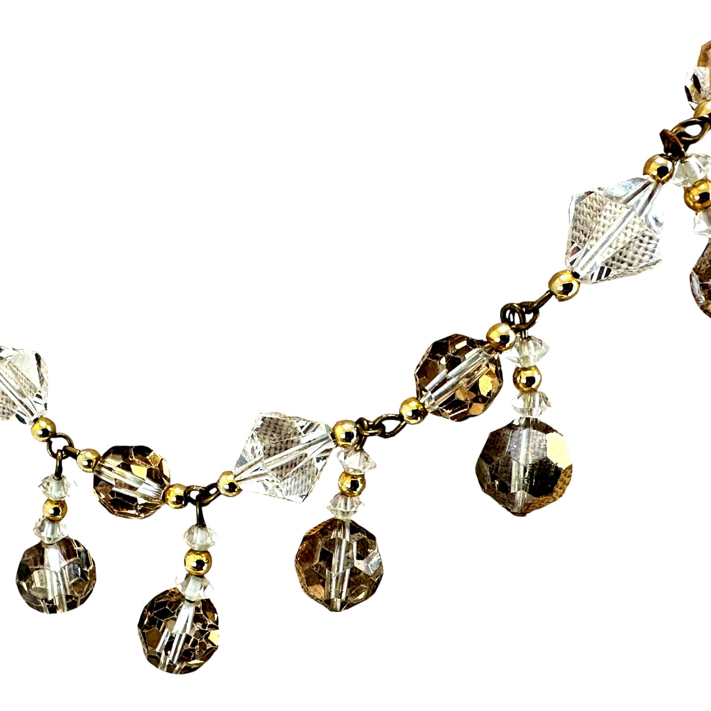 Graduated crystal fringe silhouette showing larger center drops and smaller side clusters on gold-tone brass chain with ro...