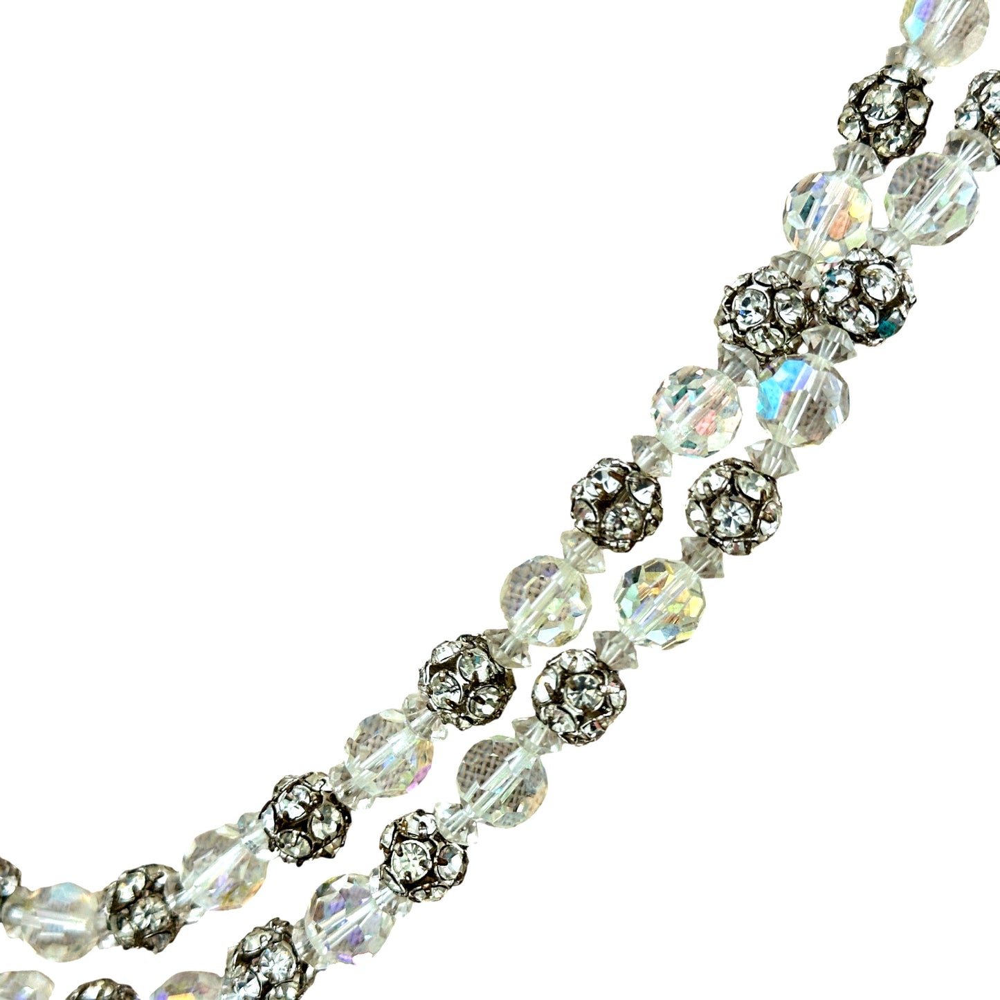 Close-up of oval box clasp set with large faceted clear crystal center stone surrounded by smaller rhinestones in silver-t...