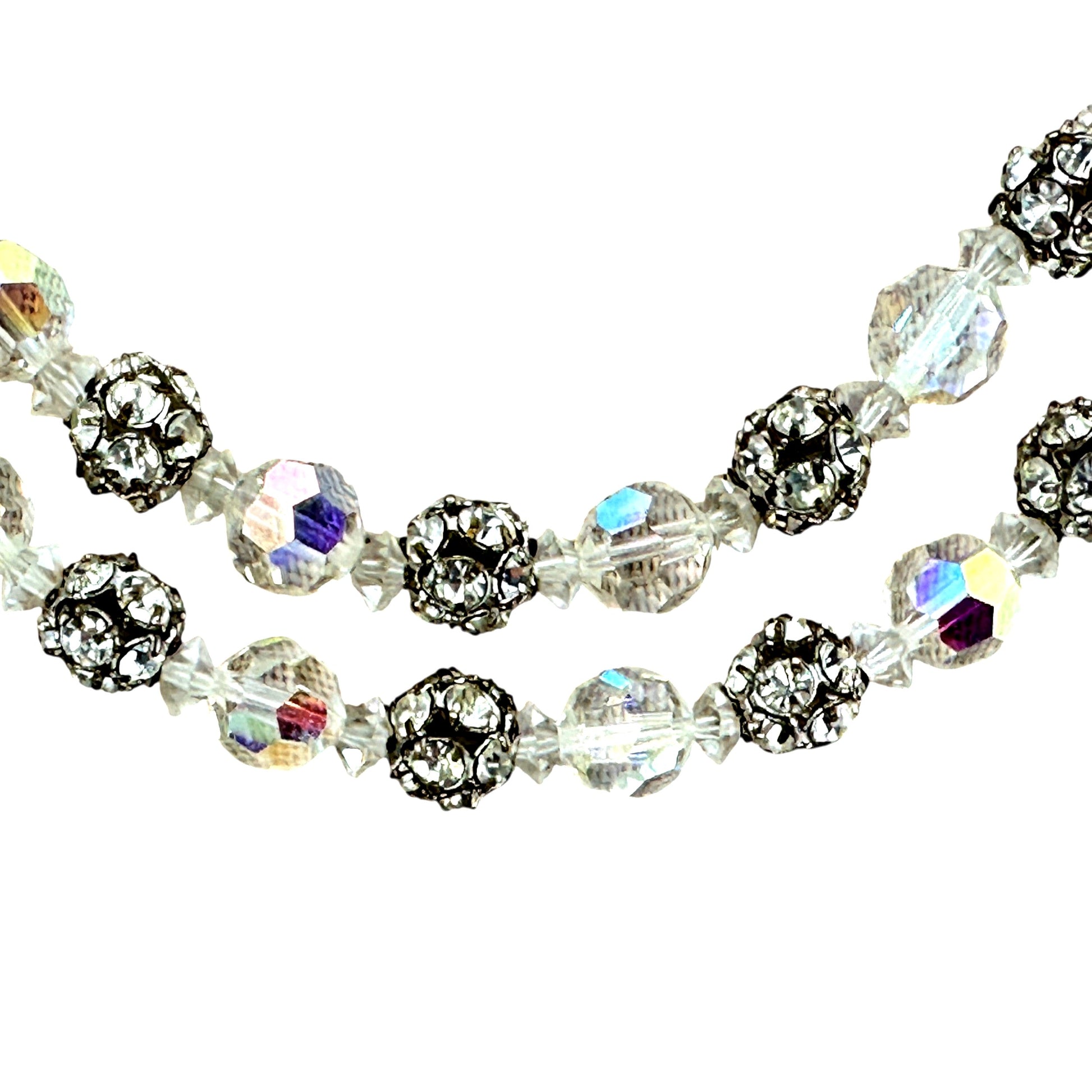 Detail of alternating faceted aurora borealis crystal beads and silver-tone rhinestone ball beads separated by small bicon...