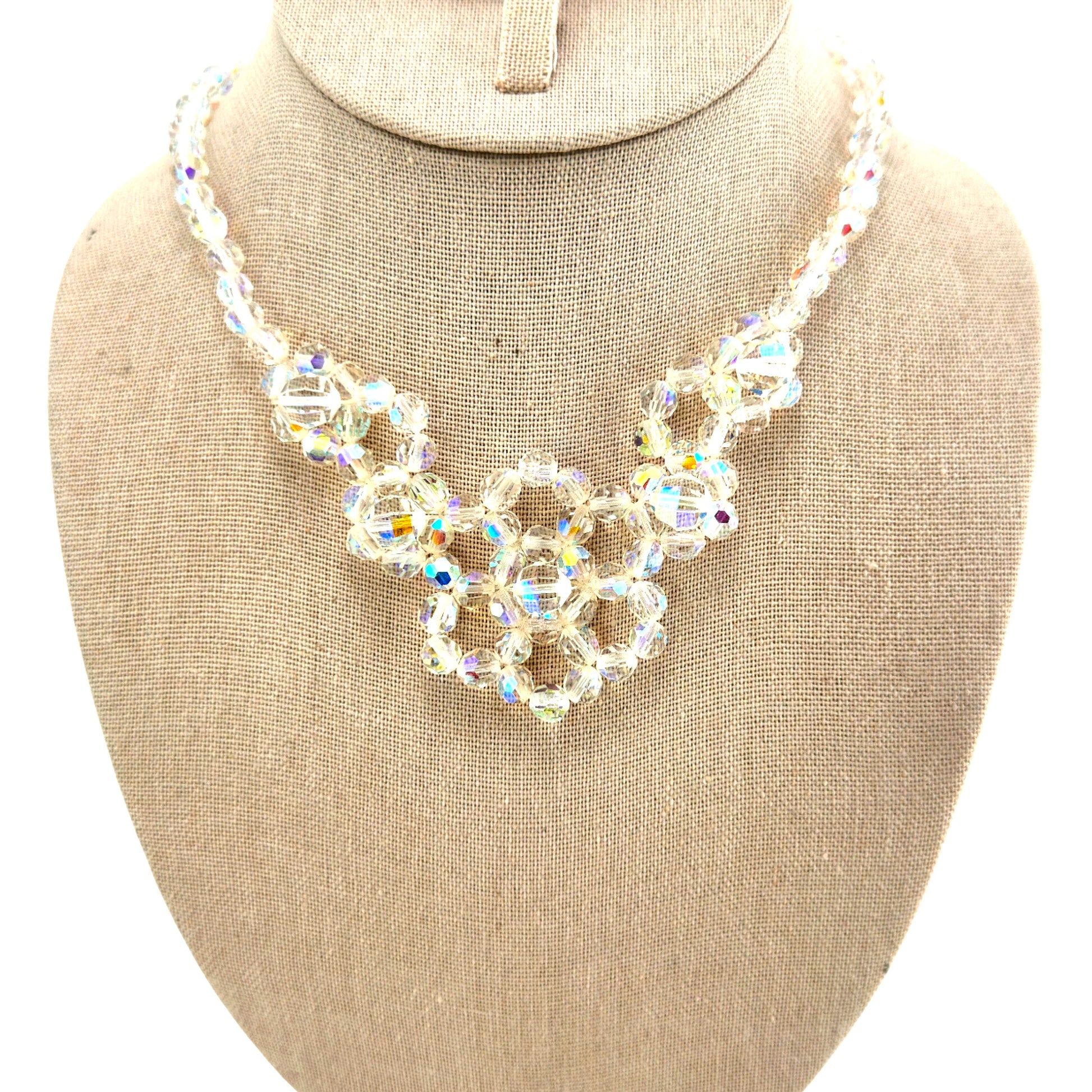 Single-strand aurora borealis crystal bib necklace with three interlocking circular flower clusters, silver-tone metal, ci...