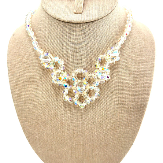 Single-strand aurora borealis crystal bib necklace with three interlocking circular flower clusters, silver-tone metal, ci...