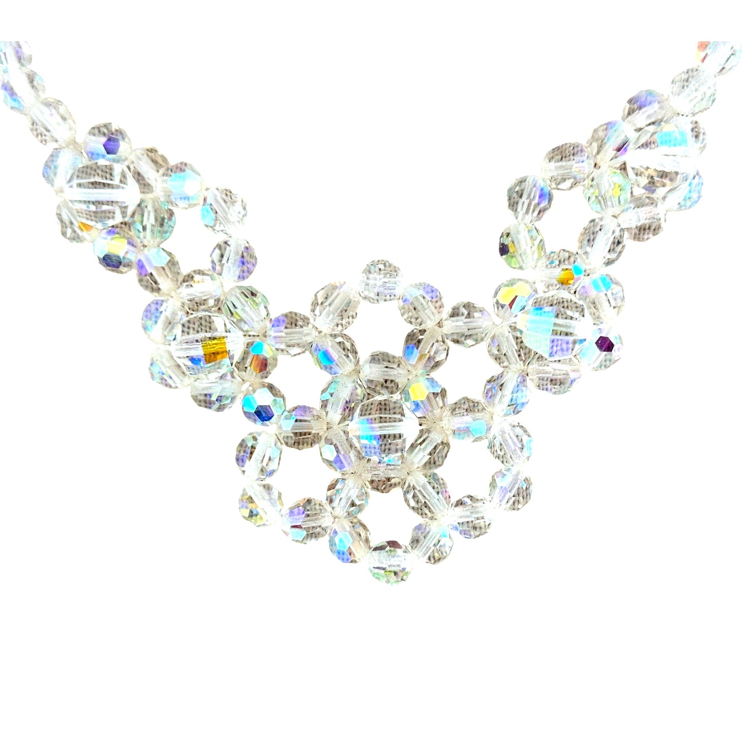 Close-up of faceted AB crystal beads wired into open circular floral clusters forming the bib centerpiece of a mid-century...