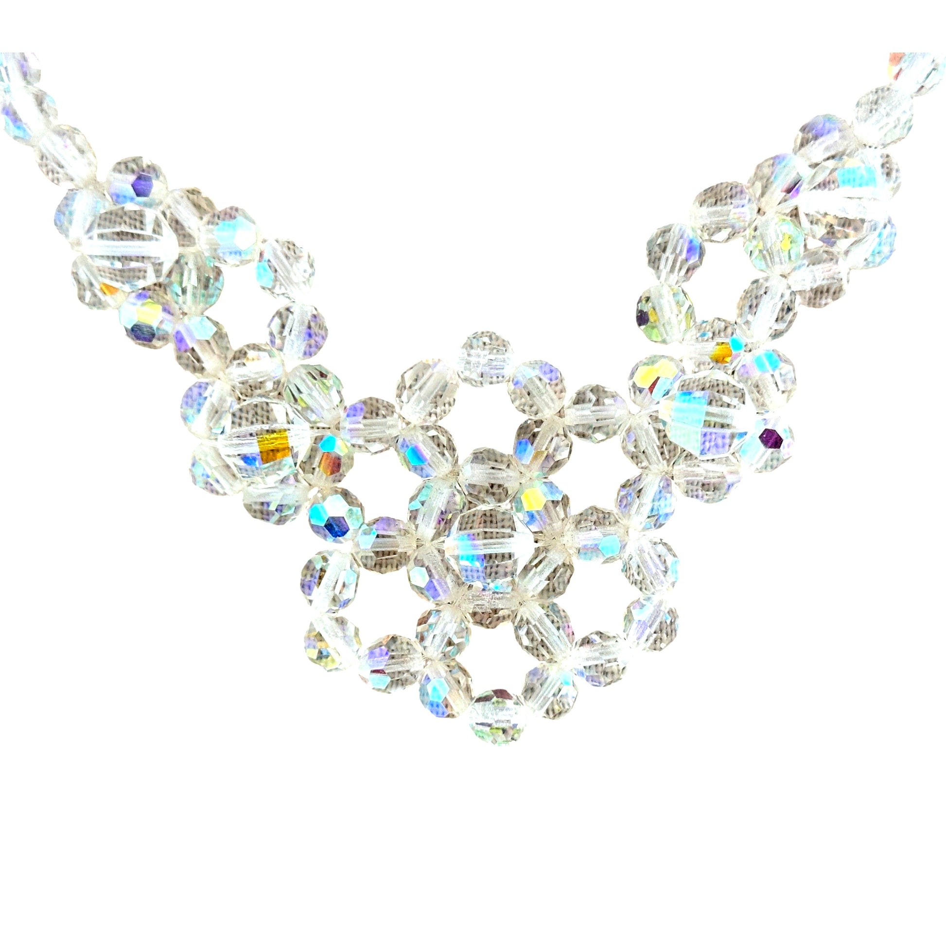 Close-up of faceted AB crystal beads wired into open circular floral clusters forming the bib centerpiece of a mid-century...