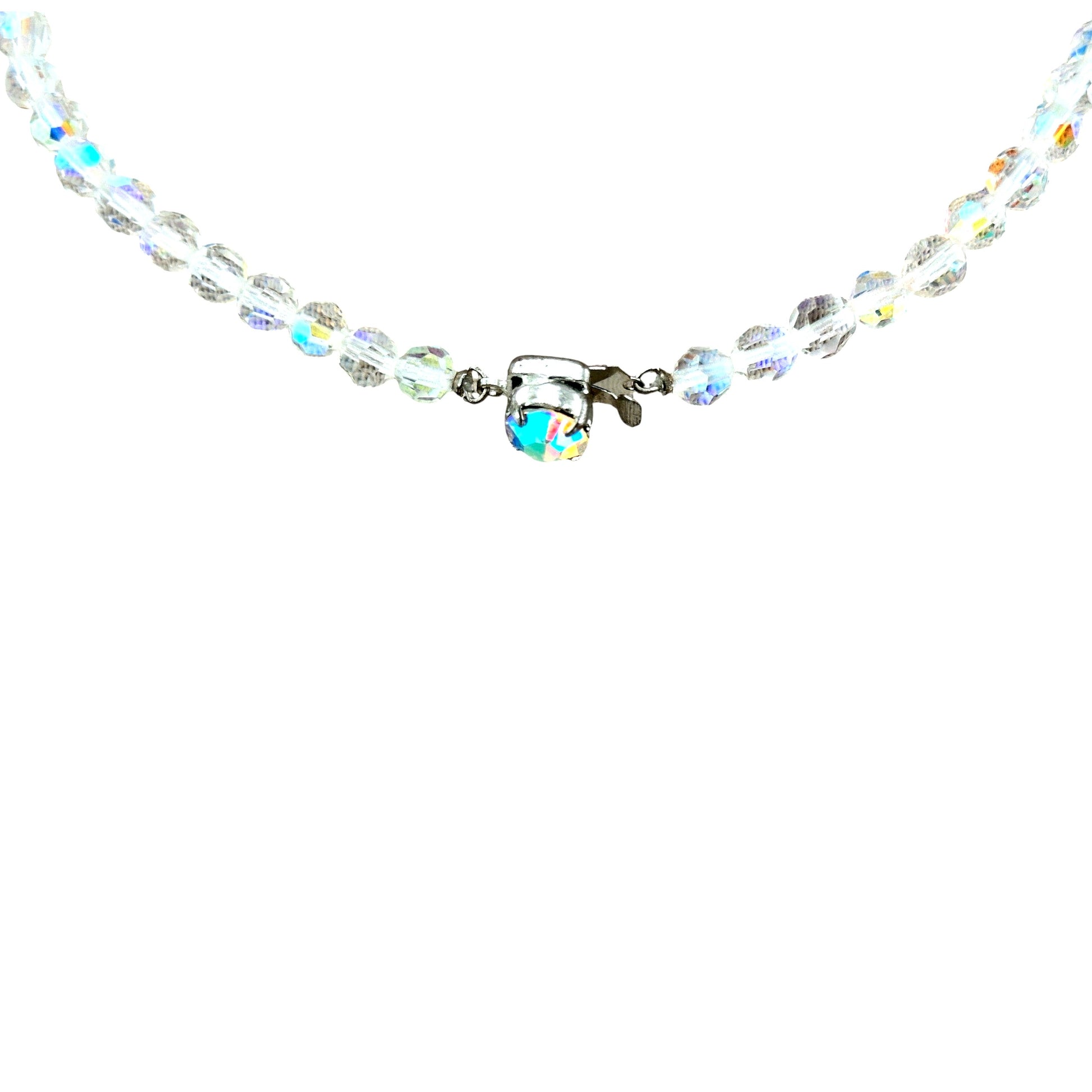 Graduating faceted aurora borealis crystal bead strand leading to a three-cluster open wirework bib, full necklace laid flat