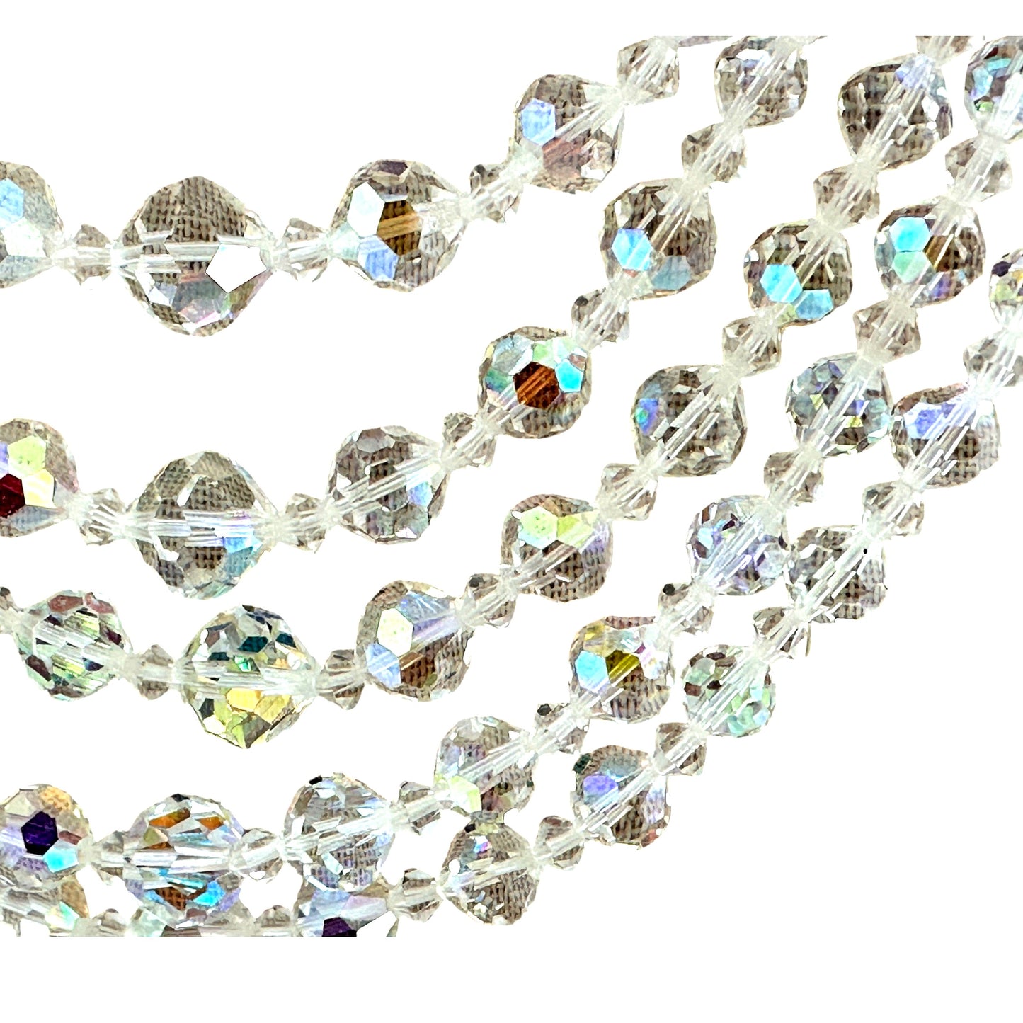 Close-up of iridescent aurora borealis coating on faceted round crystal beads ranging from 6mm to 10mm with bicone spacer ...
