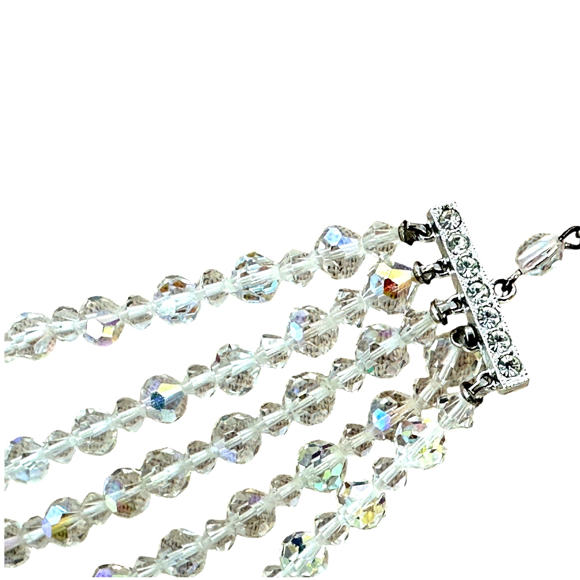 Detail of rectangular rhodium-plated slide bar clasp with channel-set clear rhinestones and five individual strand loops