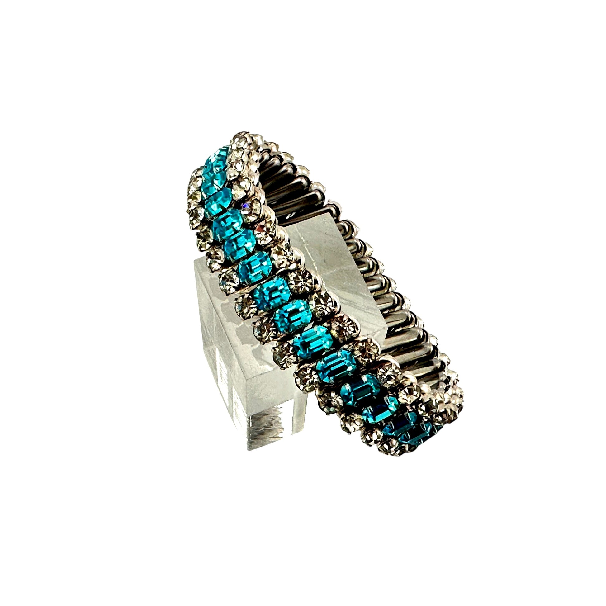 Vintage expansion bracelet with emerald-cut aqua teal rhinestones and clear round stones in silver-tone metal, on acrylic ...